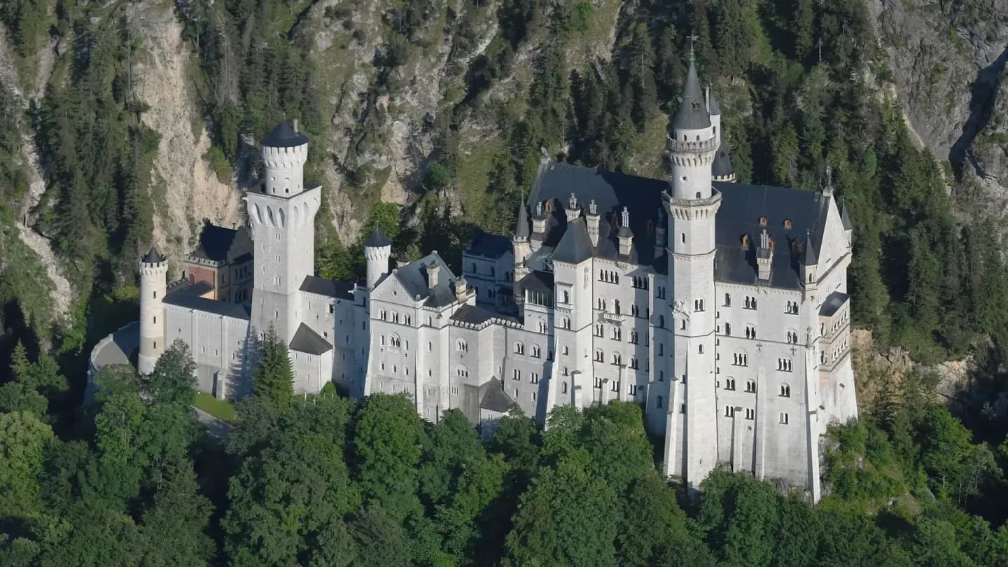 Bavarian Neuschwanstein Castle surrounded by alpine forest for Schengen visa applicants