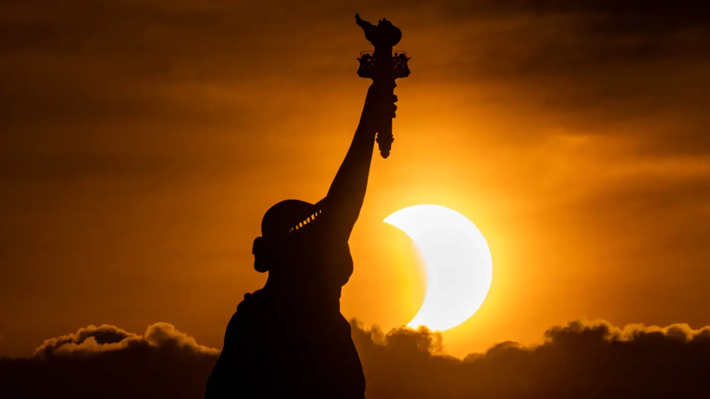 Statue of Liberty silhouette during sunset for USA visitor visa guidance